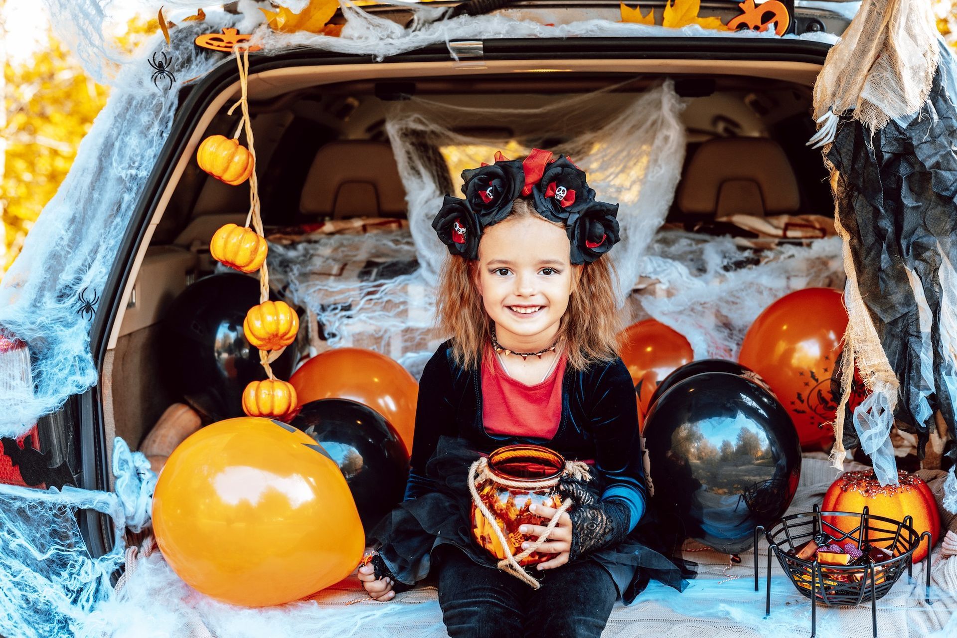 Girl sitting on trunk with decorations