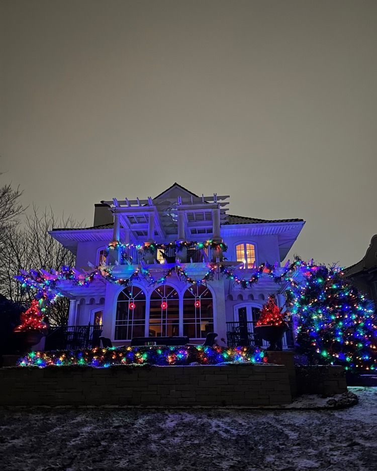 Traditional Christmas lights glowing from a historic St Paul, MN home in Highland Park
