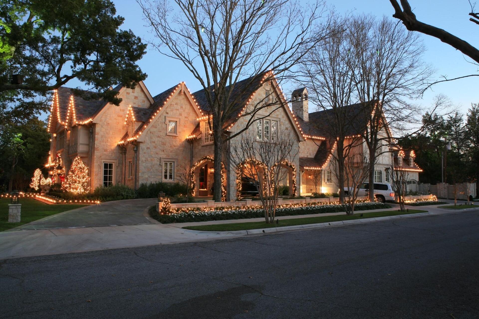 A large house is lit up with christmas lights