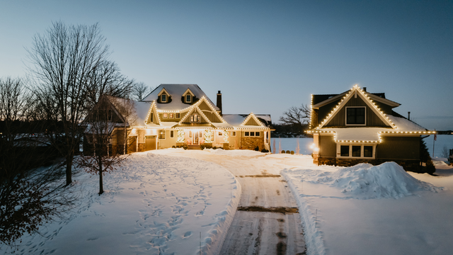 Classic white and gold Christmas lights on a lakeside home in Deephaven, MN installed by Jingle Bulbs