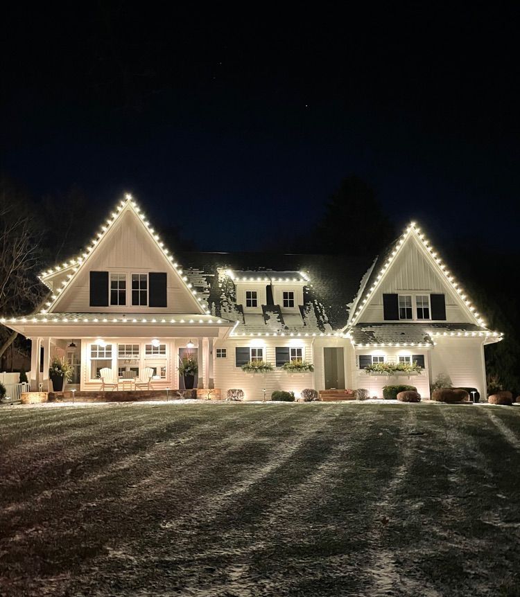 Cheerful holiday lighting on a Hanover, MN rambler set in a wooded neighborhood