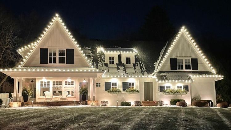 A home with professional, warm white Christmas lights. 