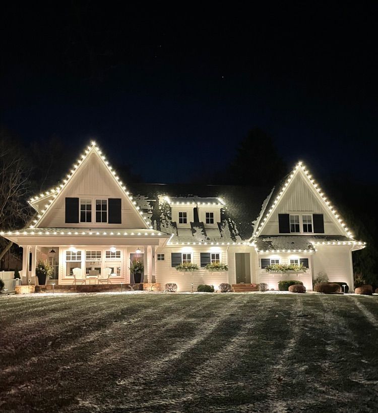 A festive mix of red and white Christmas lights on a Plymouth, MN split-level home