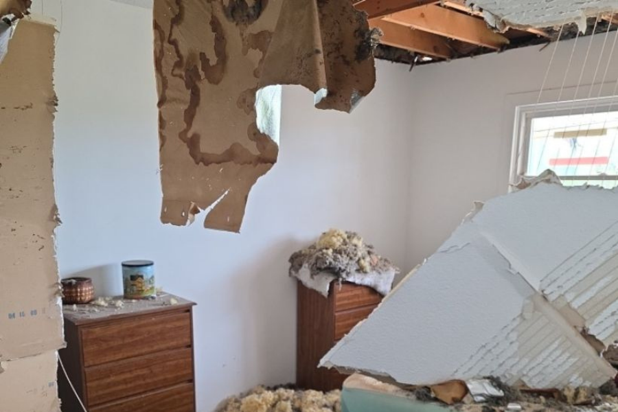 Storm damage showing collapsed roof and ceiling