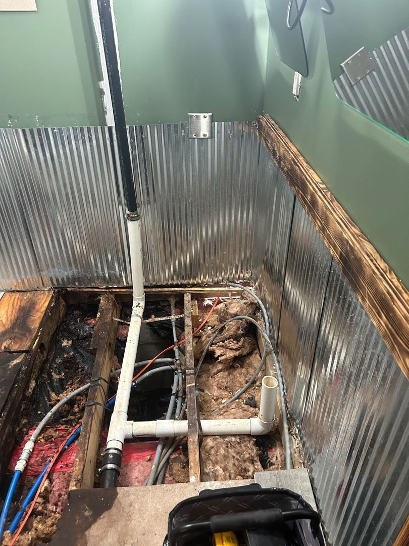 Corrugated metal accent wall installed during Hartville bathroom rebuild after water damage