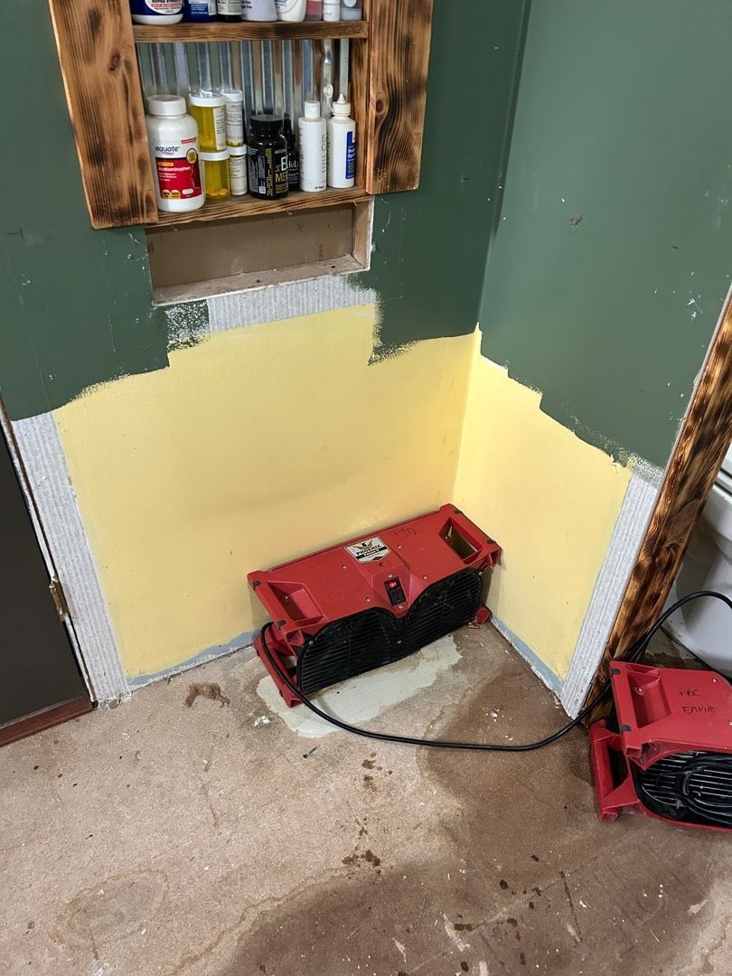 Wall cavity opened for drying with equipment visible in Hartville bathroom restoration