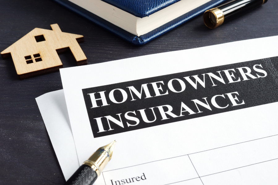 Homeowner reviewing insurance policy documents at kitchen table