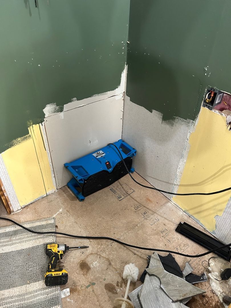 Air mover positioned at lower wall for targeted drying in water damaged Hartville bathroom