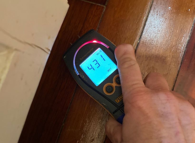 moisture meter reading on hardwood floor