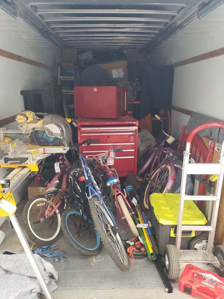 Household contents loaded into moving truck during pack-out