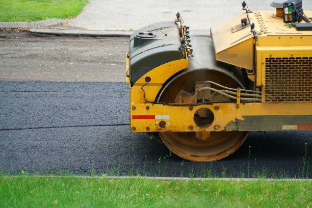 A Yellow Roller is Rolling Asphalt on a Road | Fayetteville, NC - Johnson’s Asphalt