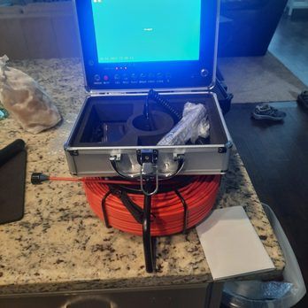 A briefcase with a monitor and a hose on a counter top