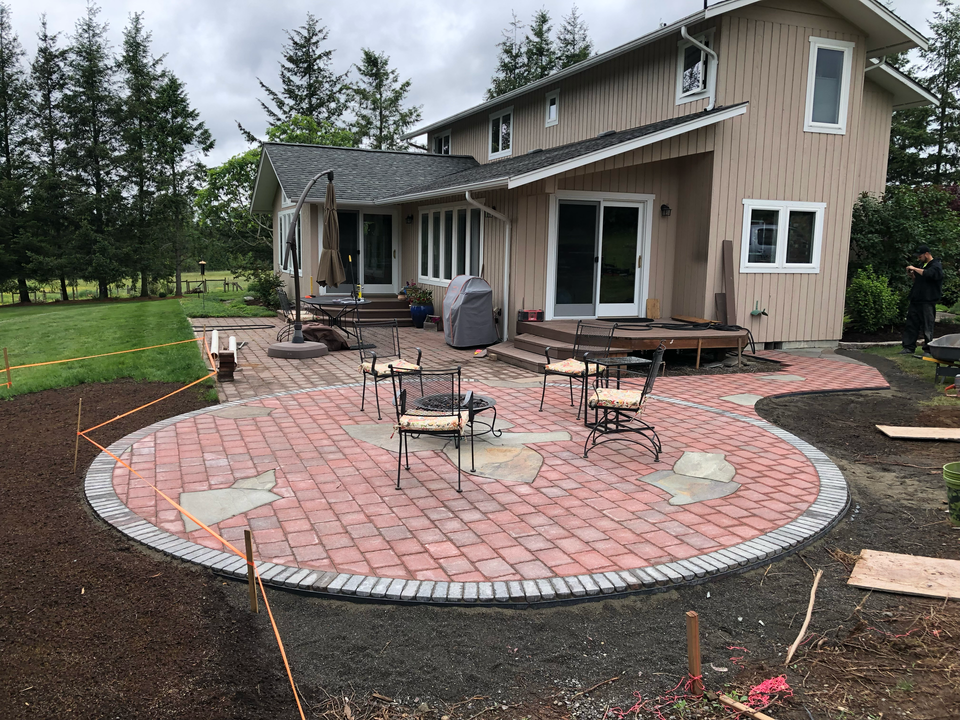 Brick patio with seating in front of a house; work by West Coast Landscape & Hardscape. 