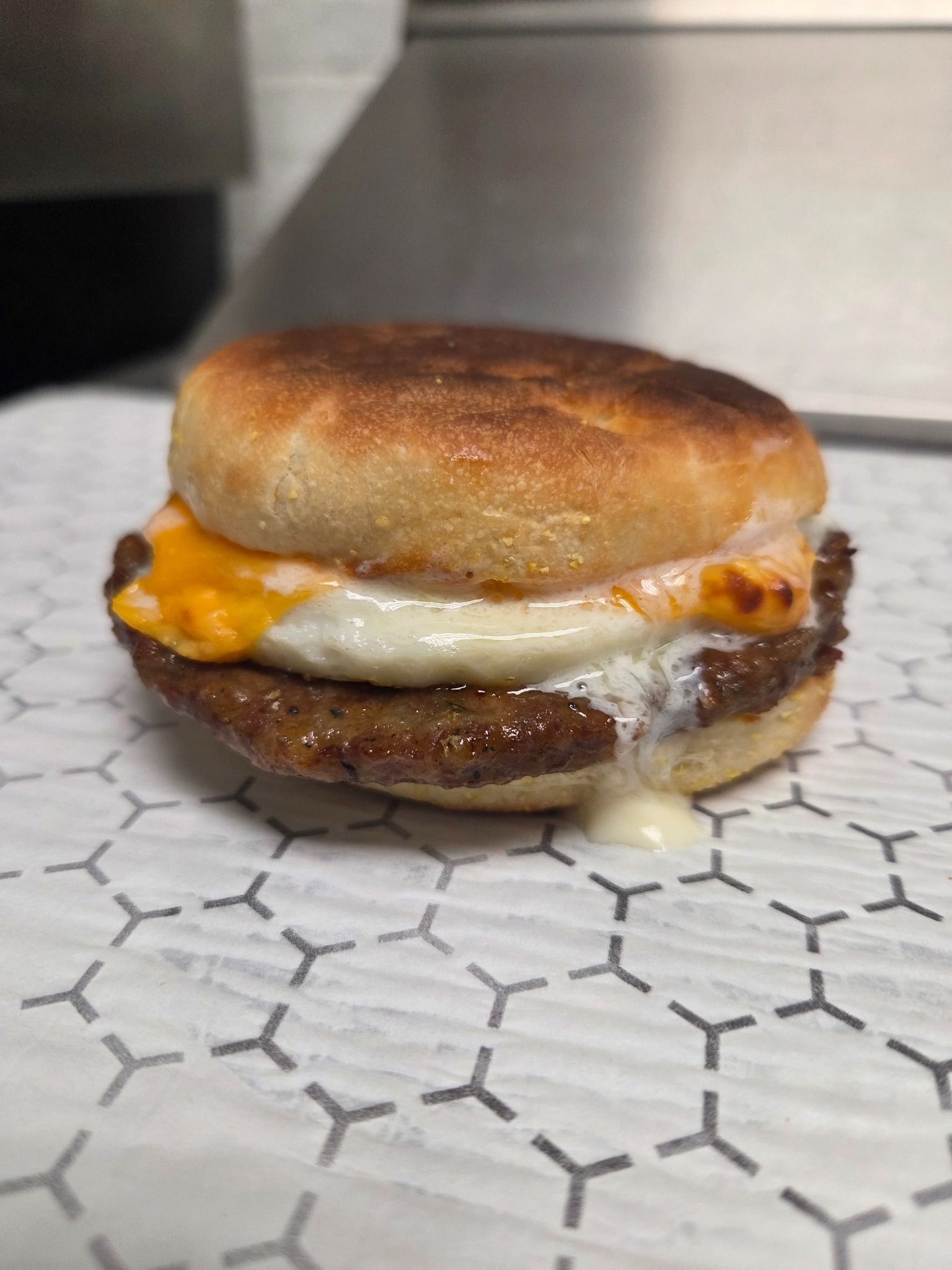 Sausage McMuffin with egg and cheese on paper.