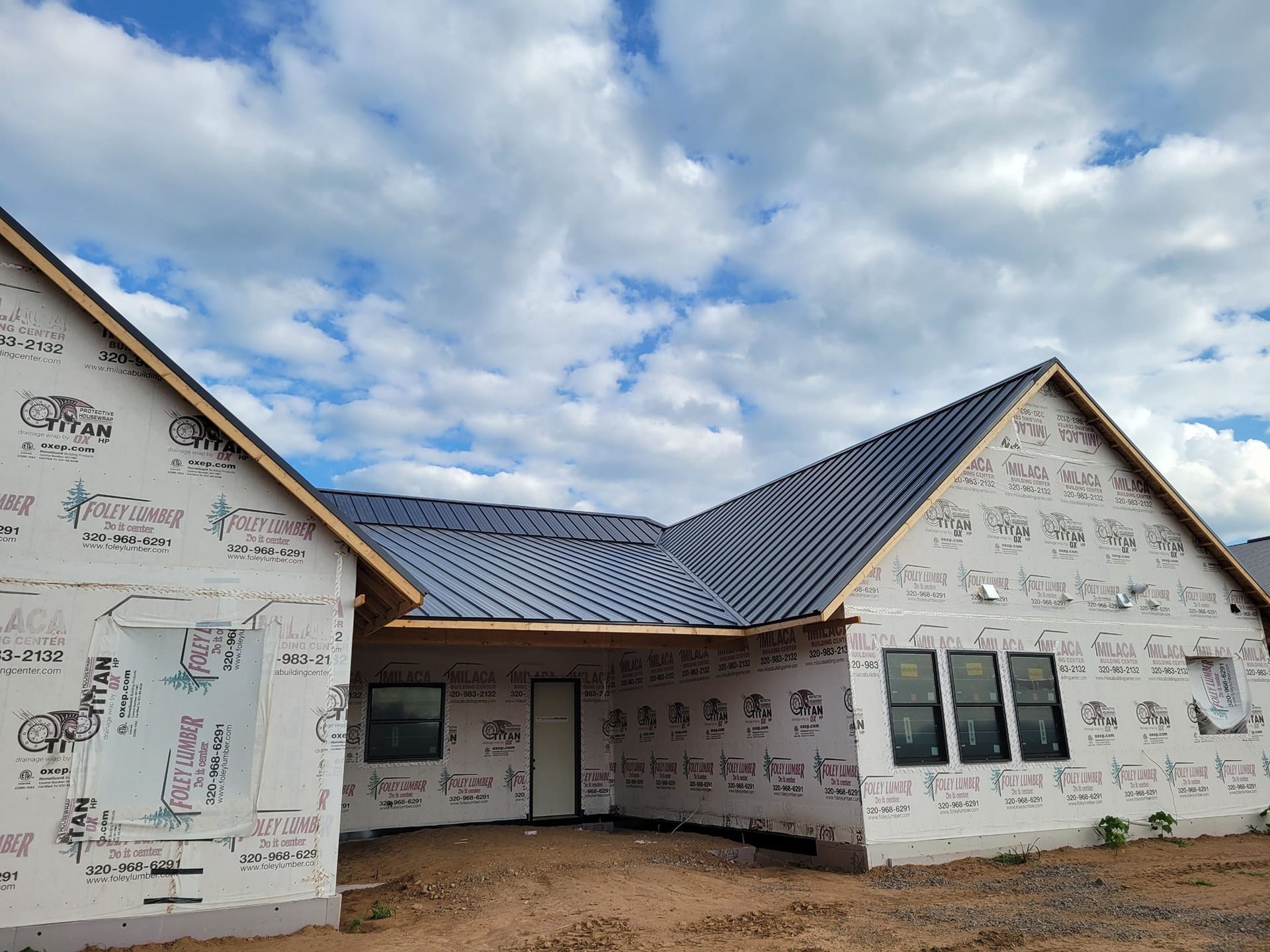 A house is being built with a metal roof.