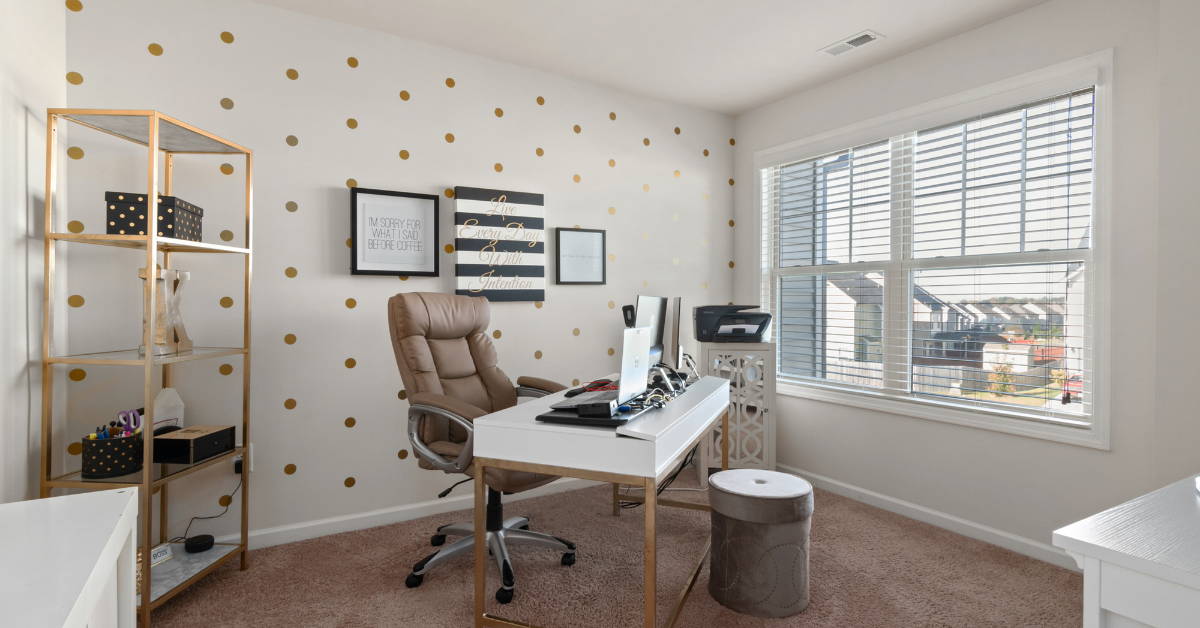 A home office with a desk , chair , computer and printer.
