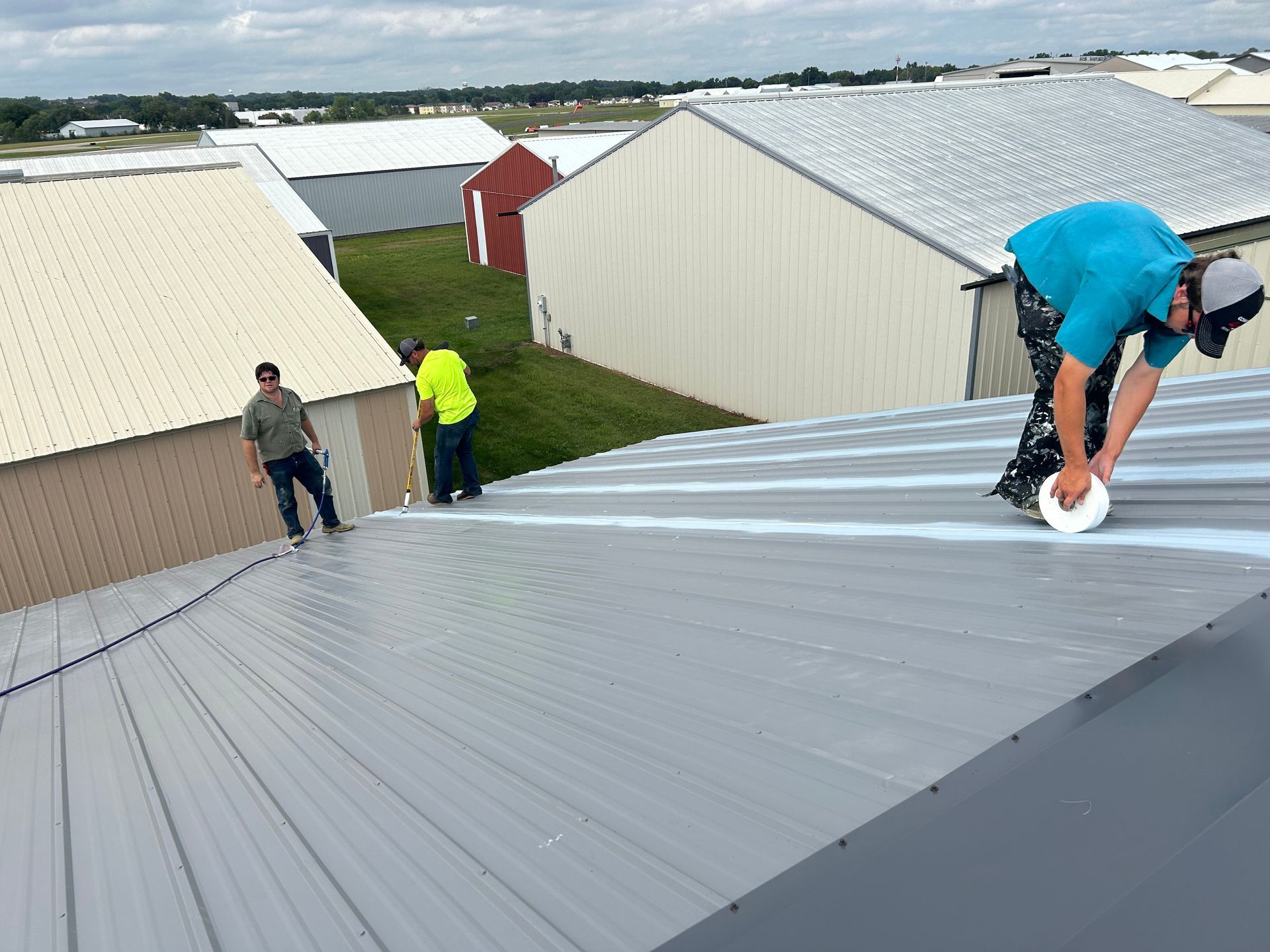 A group of people are working on a roof.