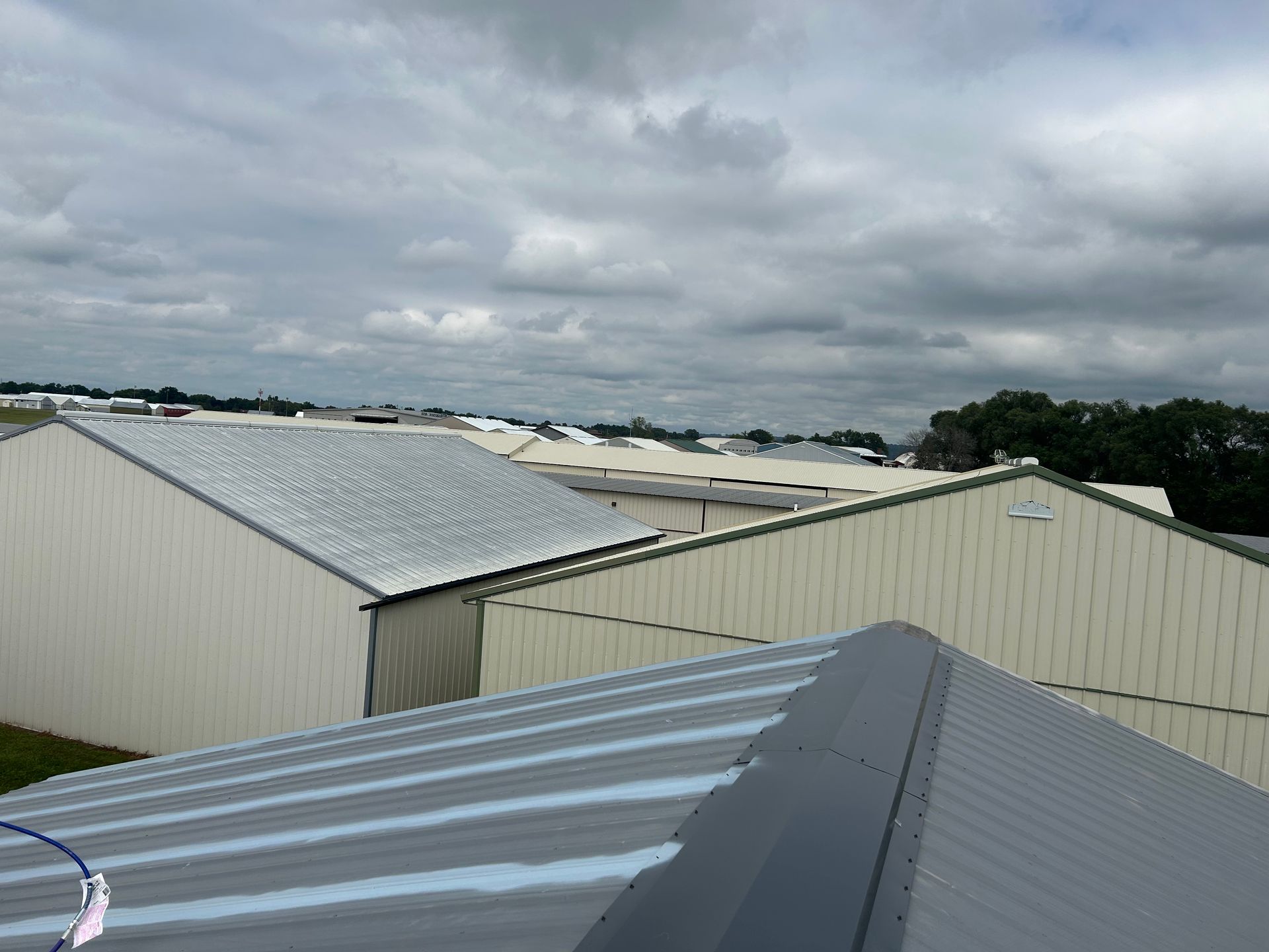 A roof of a building with a cloudy sky in the background.