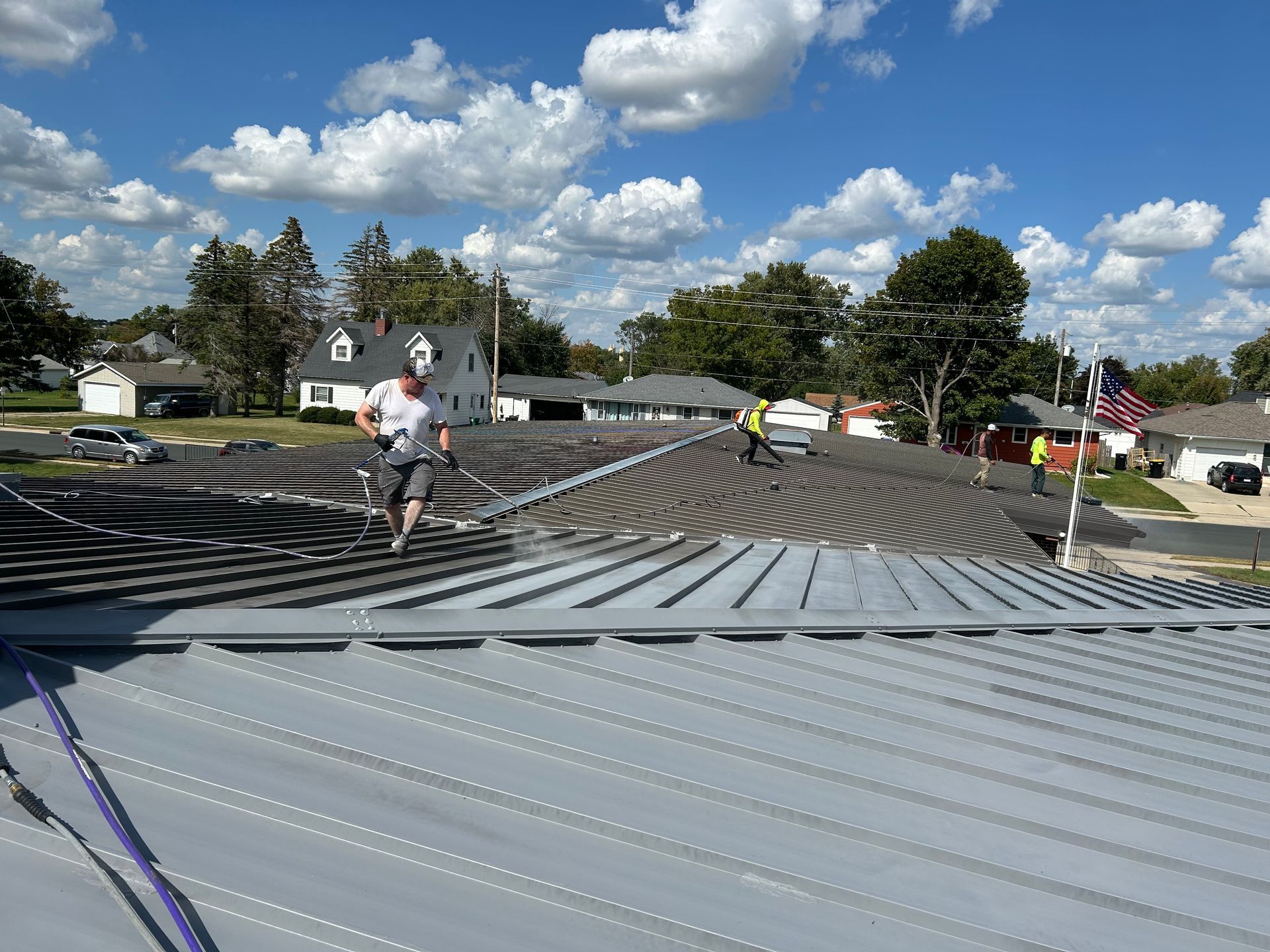 A man is working on the roof of a building.