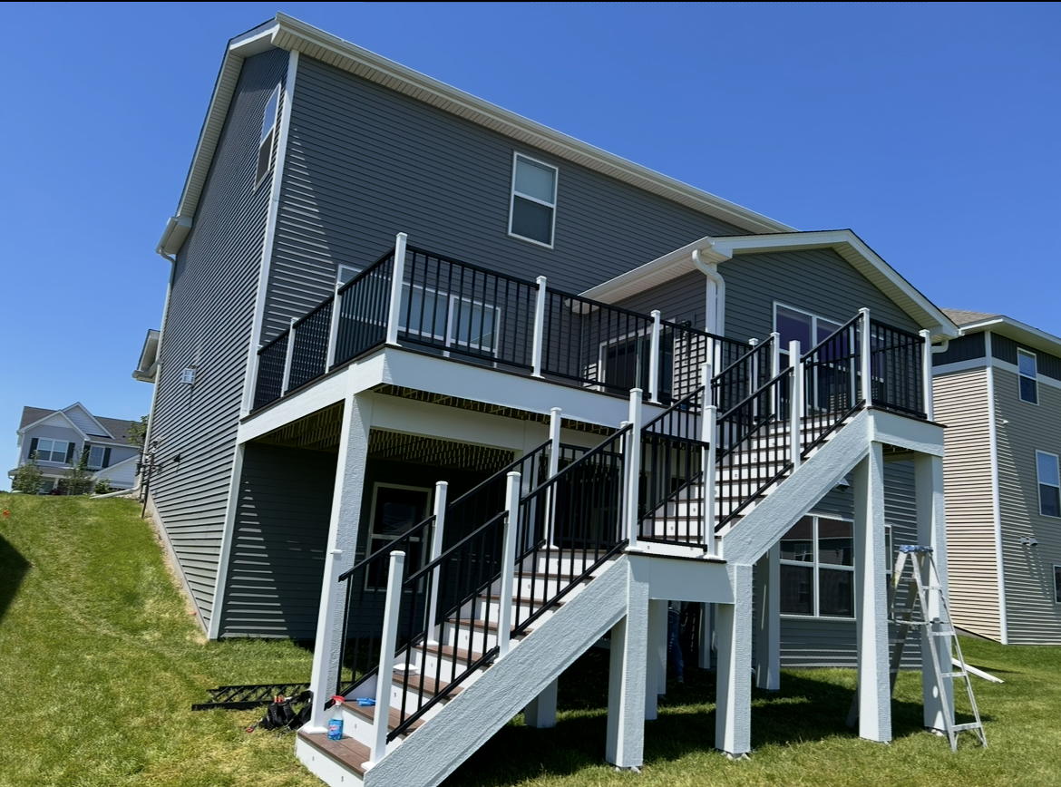The back of a house with a deck and stairs.
