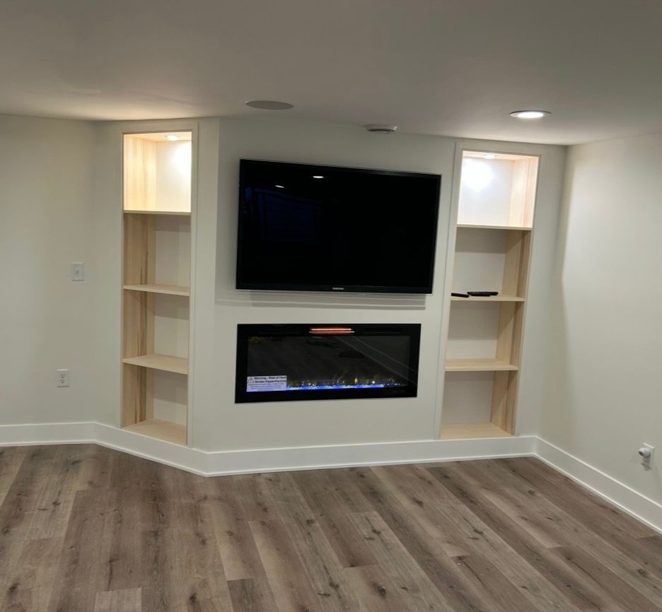 A living room with a fireplace and a flat screen tv