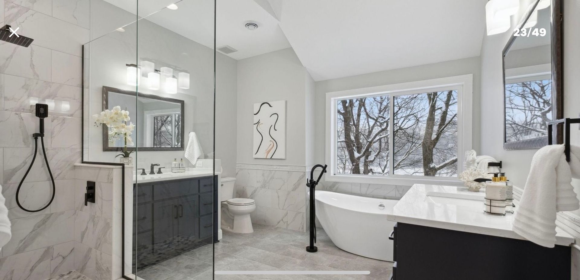A bathroom with a tub , sink , toilet and shower.