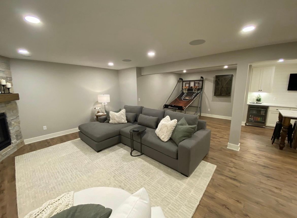 A living room with a couch , chair , and fireplace.