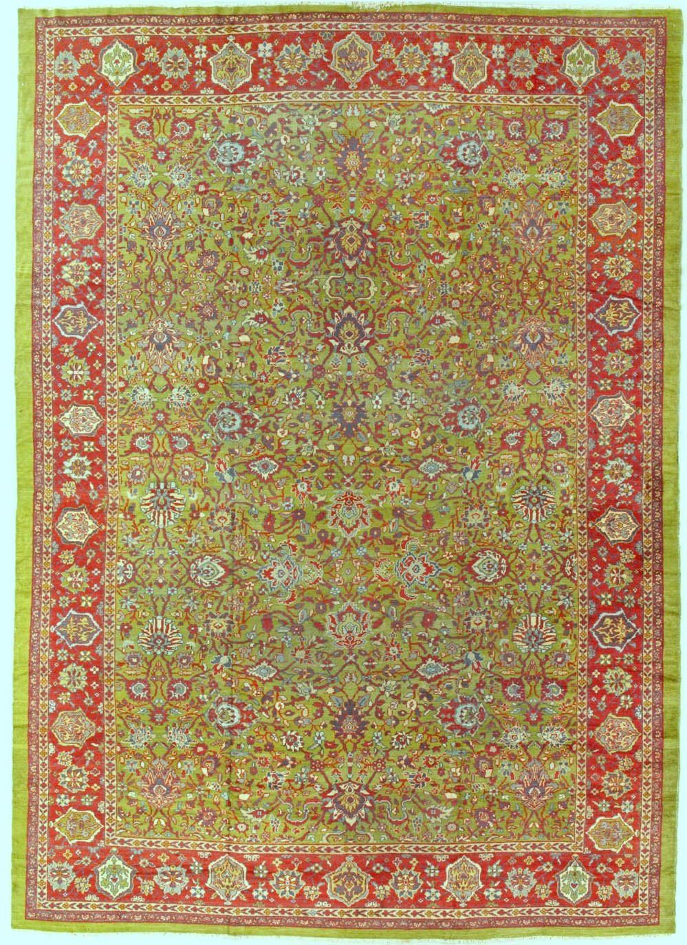 A red and green rug with a floral pattern on it