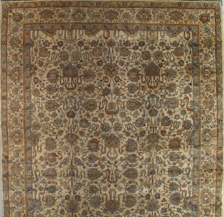 A rug with a pattern of flowers and leaves on it