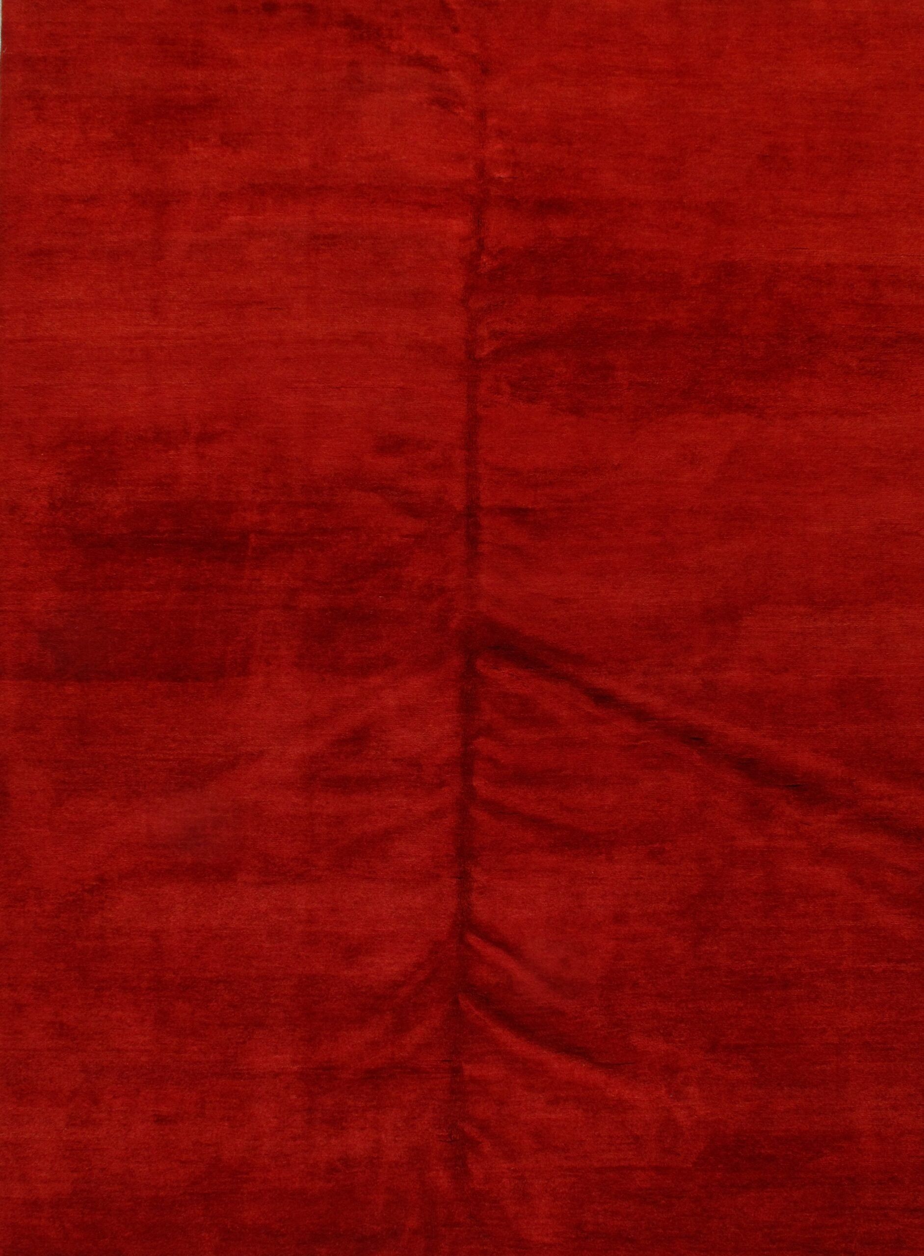 A close up of a red fabric with a texture.