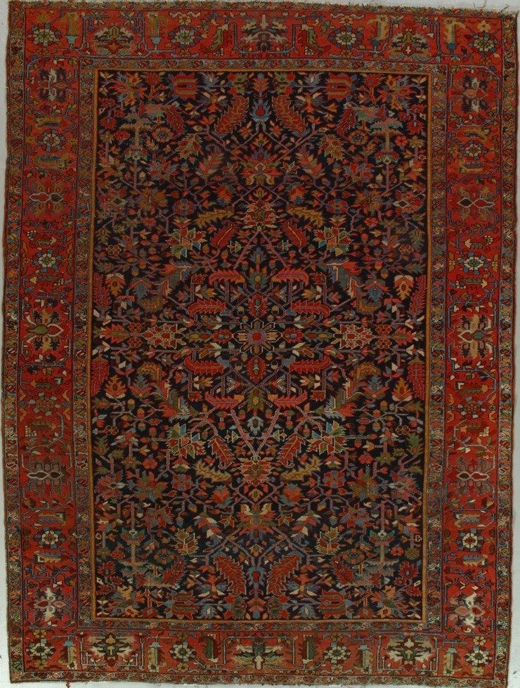 A rug with a floral pattern on it is sitting on a white surface.