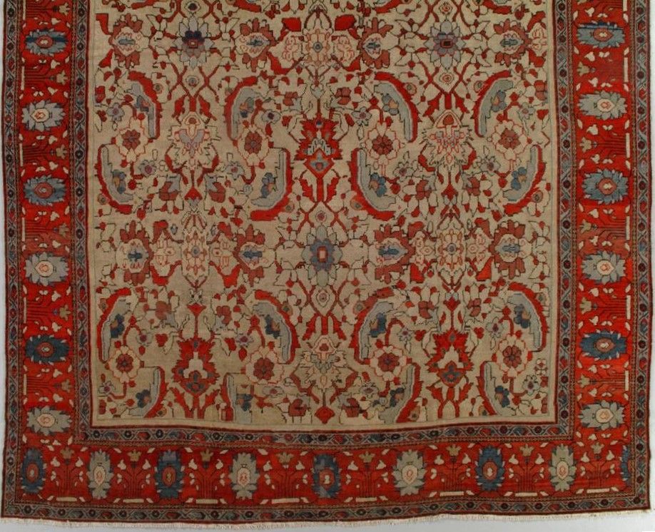 Red, cream, and blue patterned Oriental rug with floral motifs and a red border.