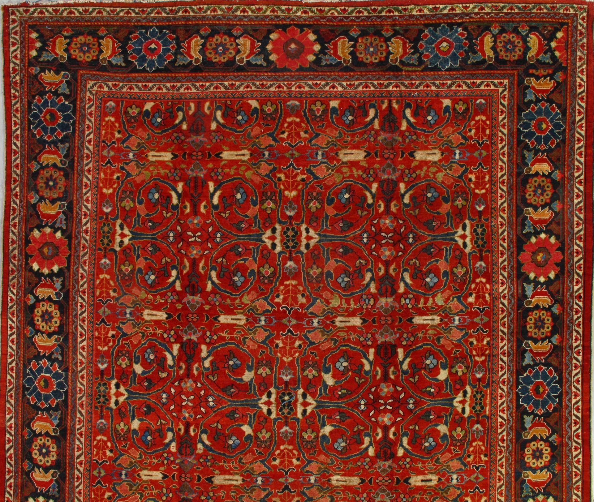 A red rug with a floral pattern on it