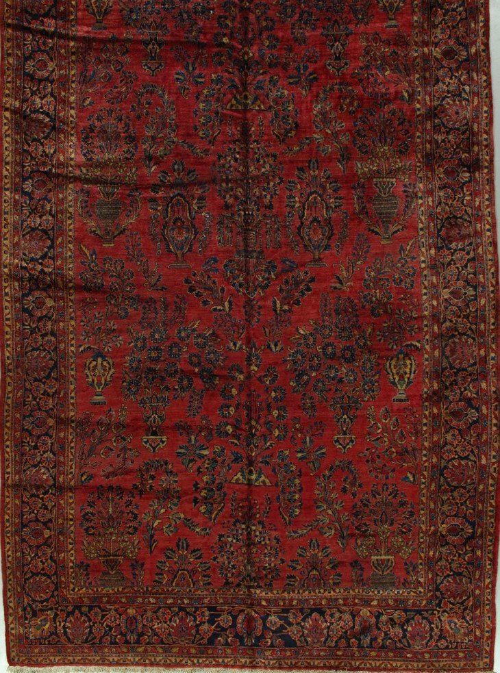 A red rug with a floral pattern on it