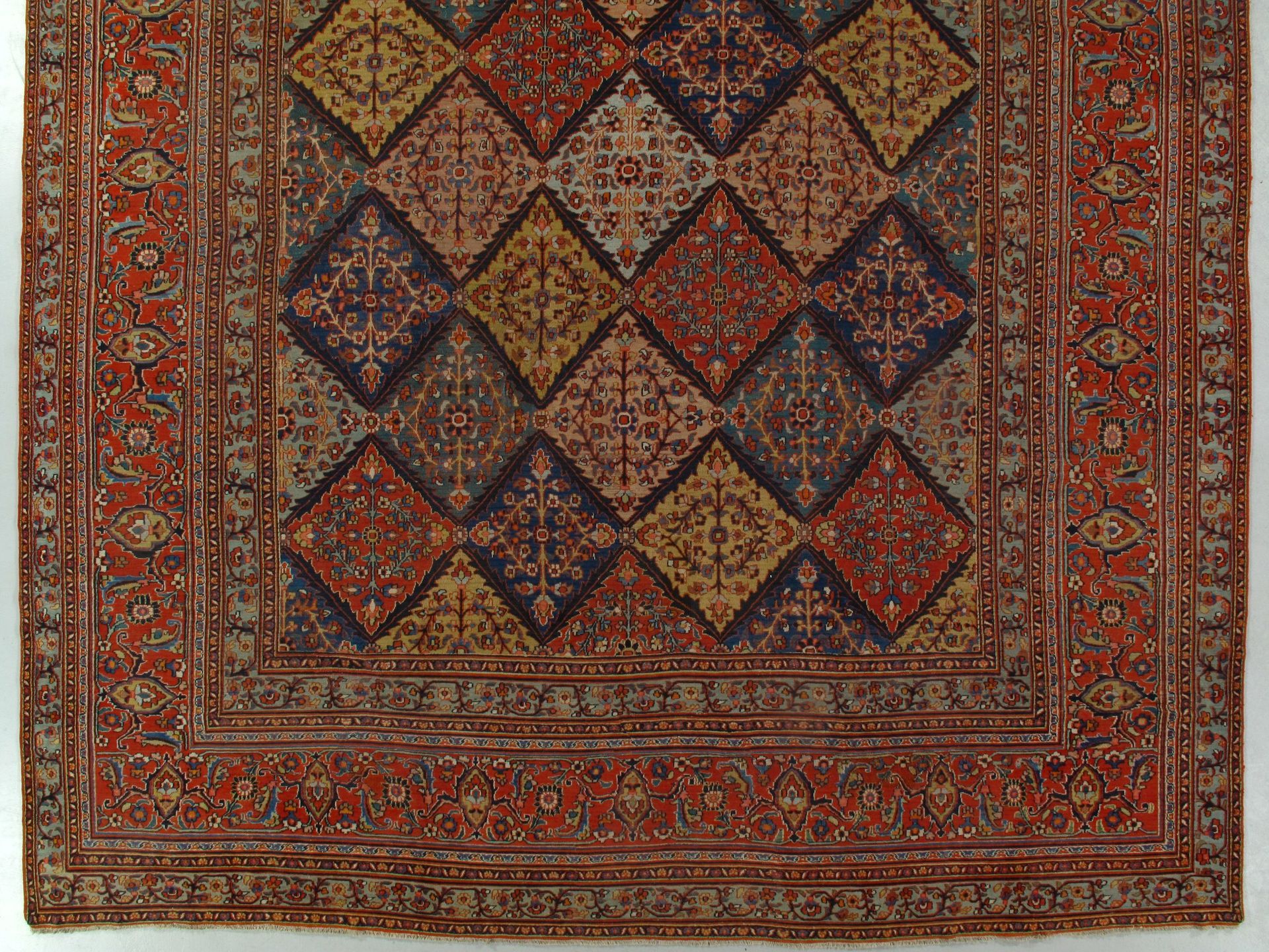 A rug with a pattern of squares on it is on a white background.