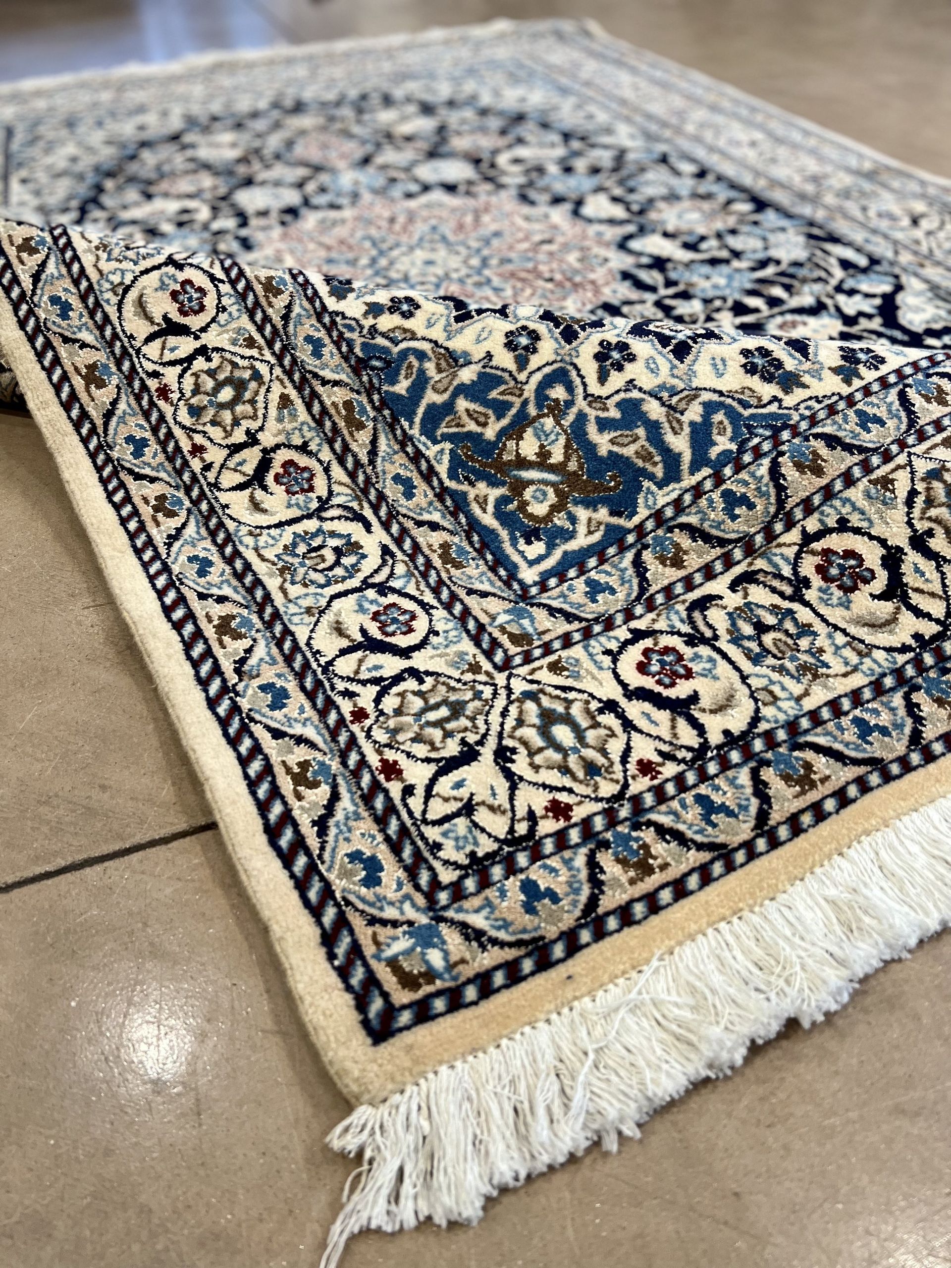 A close up of a rug with a floral pattern on it.