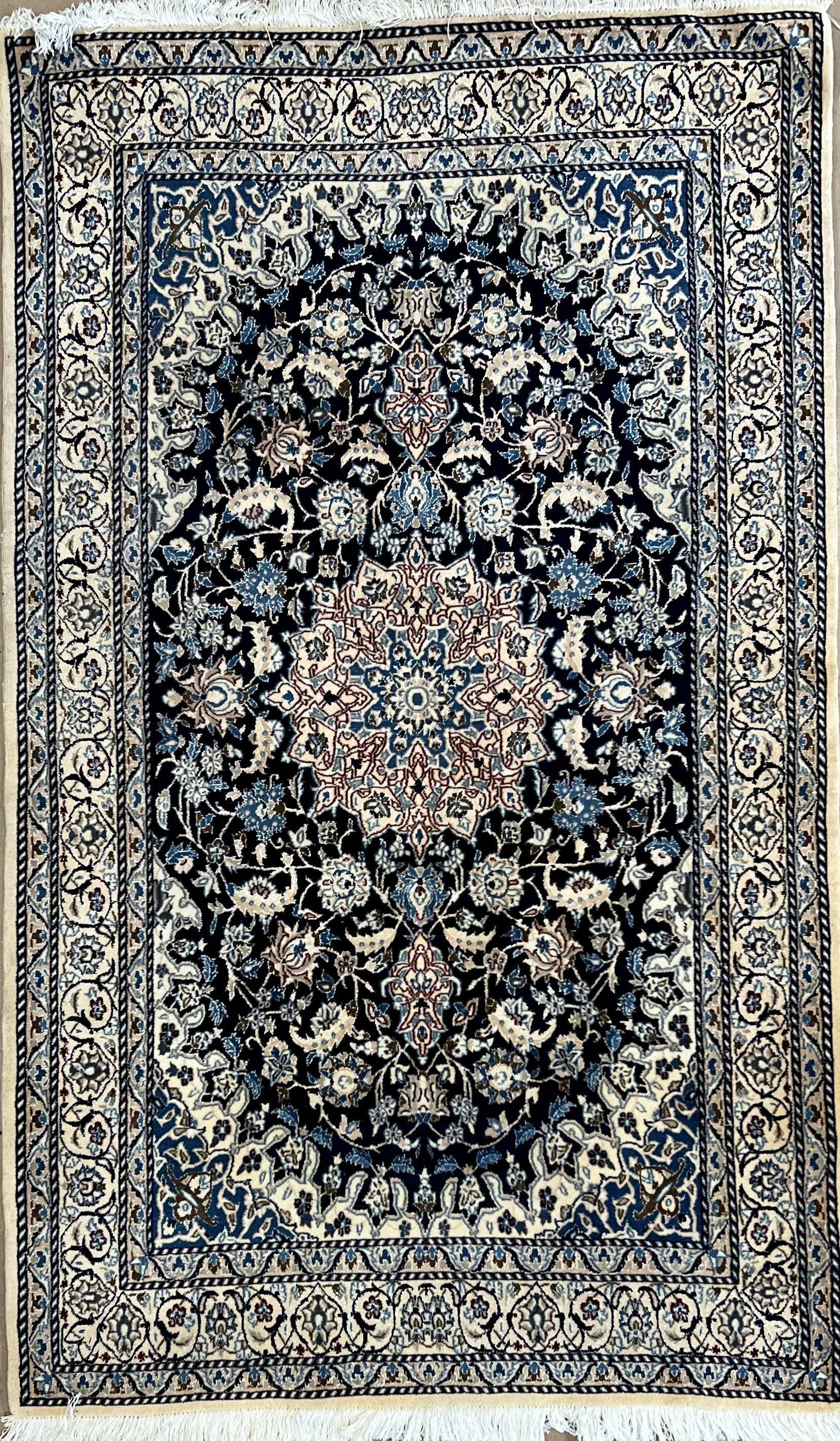 A close up of a rug with a floral pattern on it.
