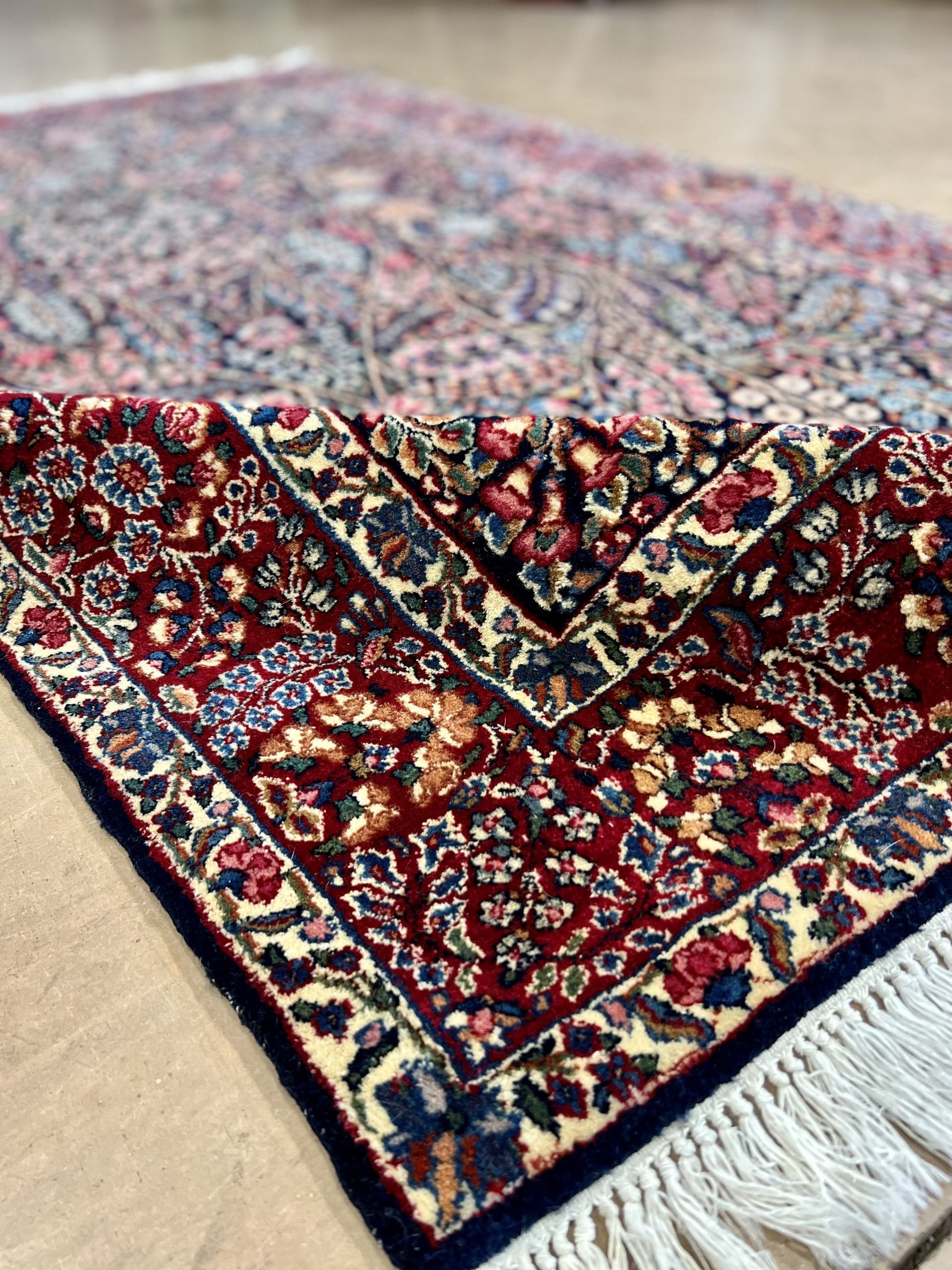 A close up of a rug with a floral pattern on it.