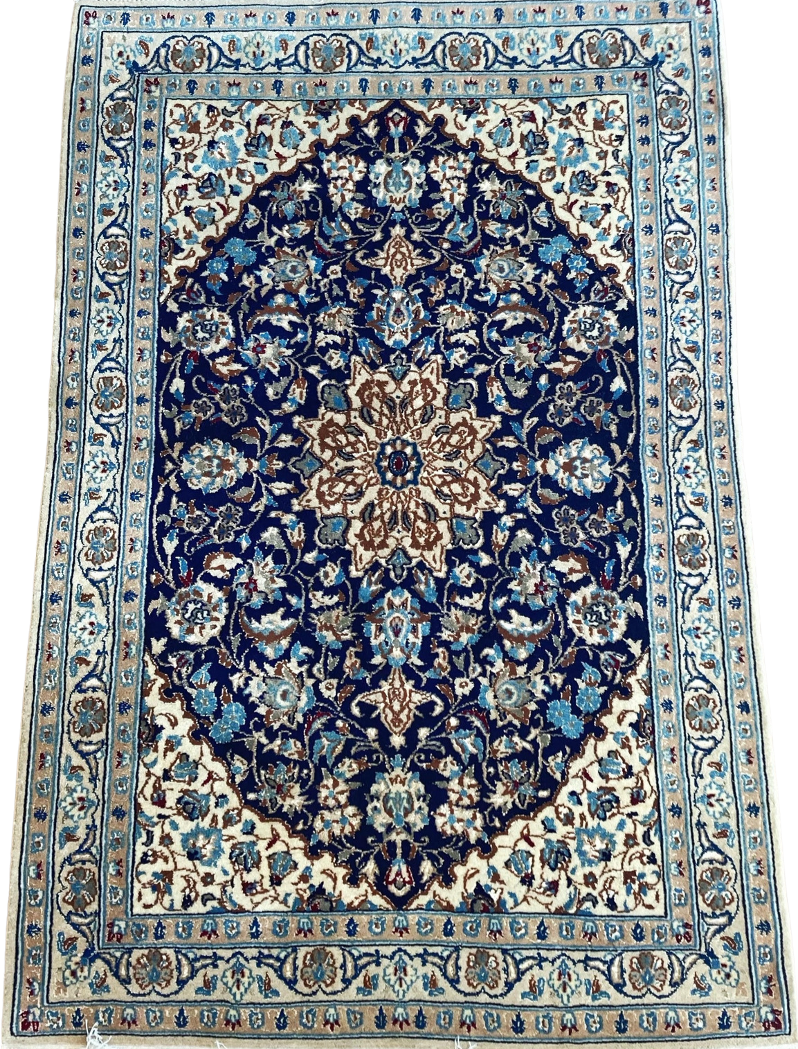 A blue and white rug with a floral pattern on a white background.