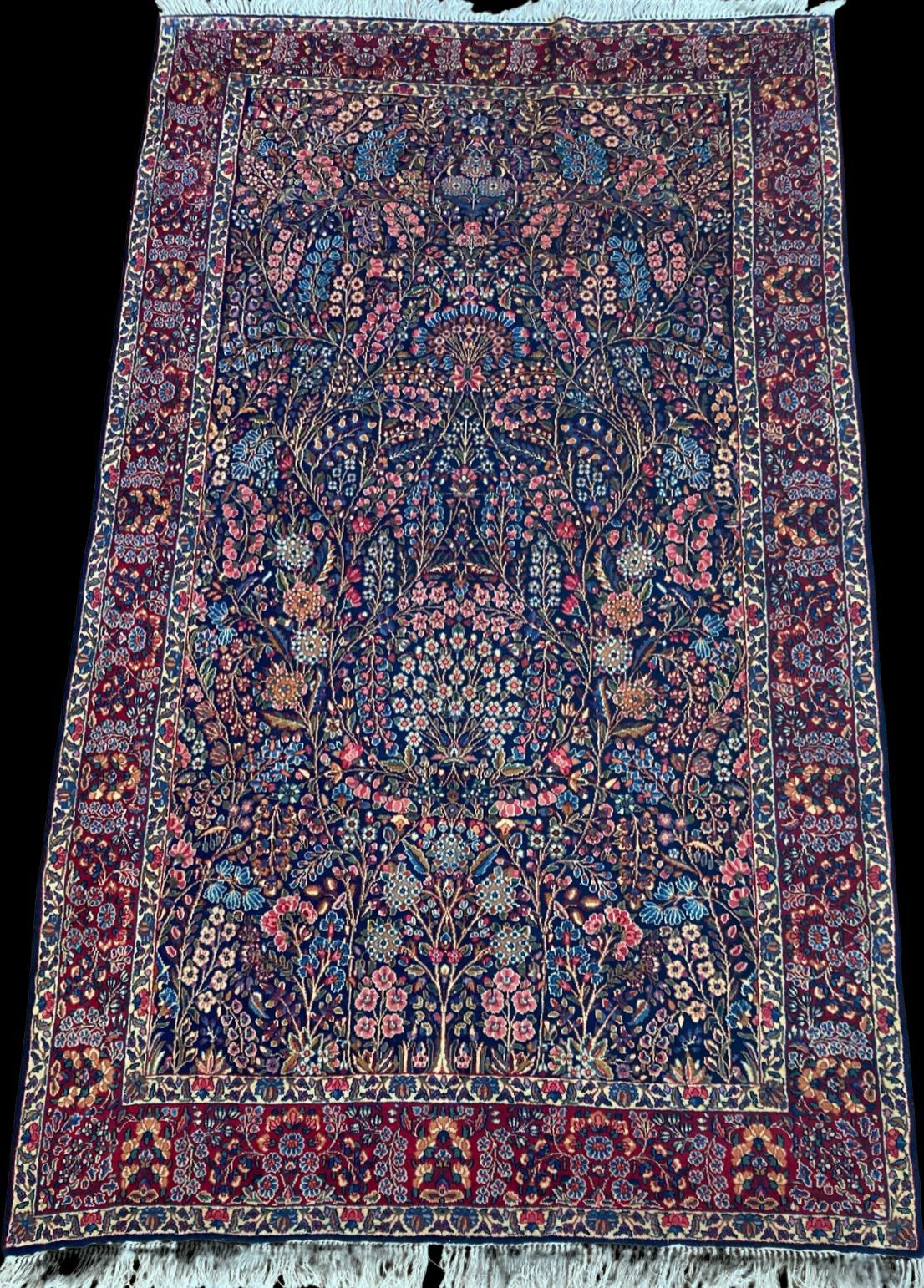 A rug with a floral pattern on it is sitting on a table.
