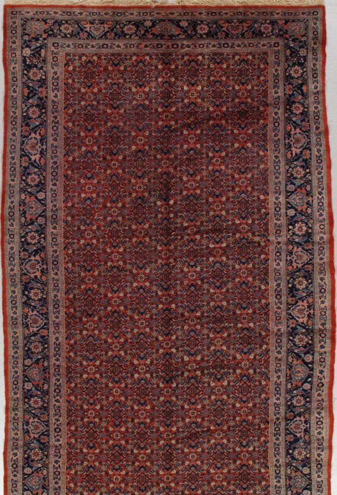 A rug with a floral pattern on it is sitting on a white surface.