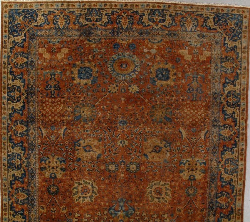 A square rug with a floral pattern on it
