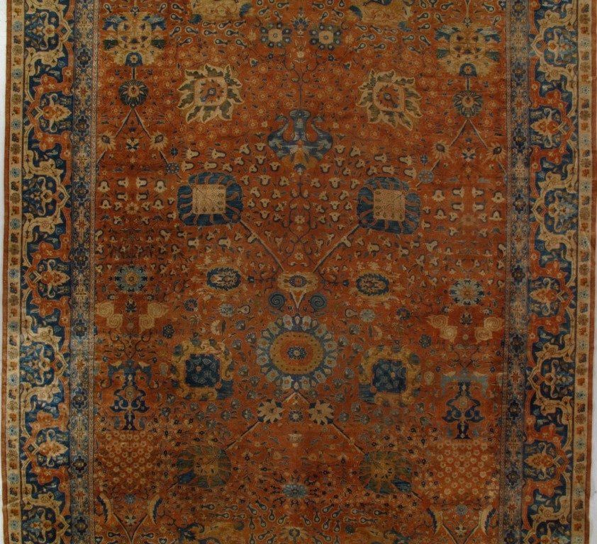 A square rug with a floral pattern on it
