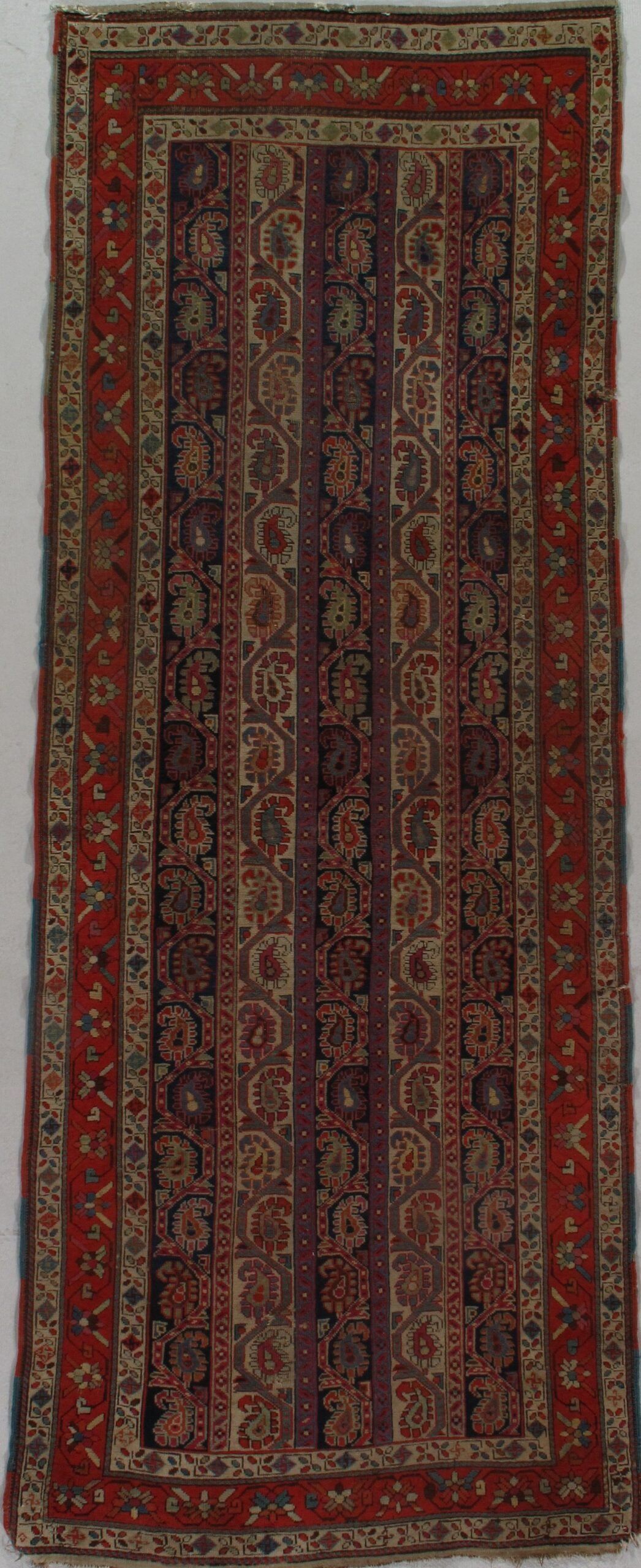 A rug with a pattern on it is sitting on a white surface.