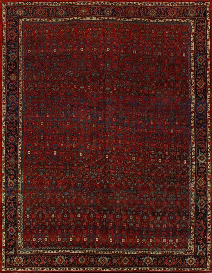 A red rug with a floral pattern and a border