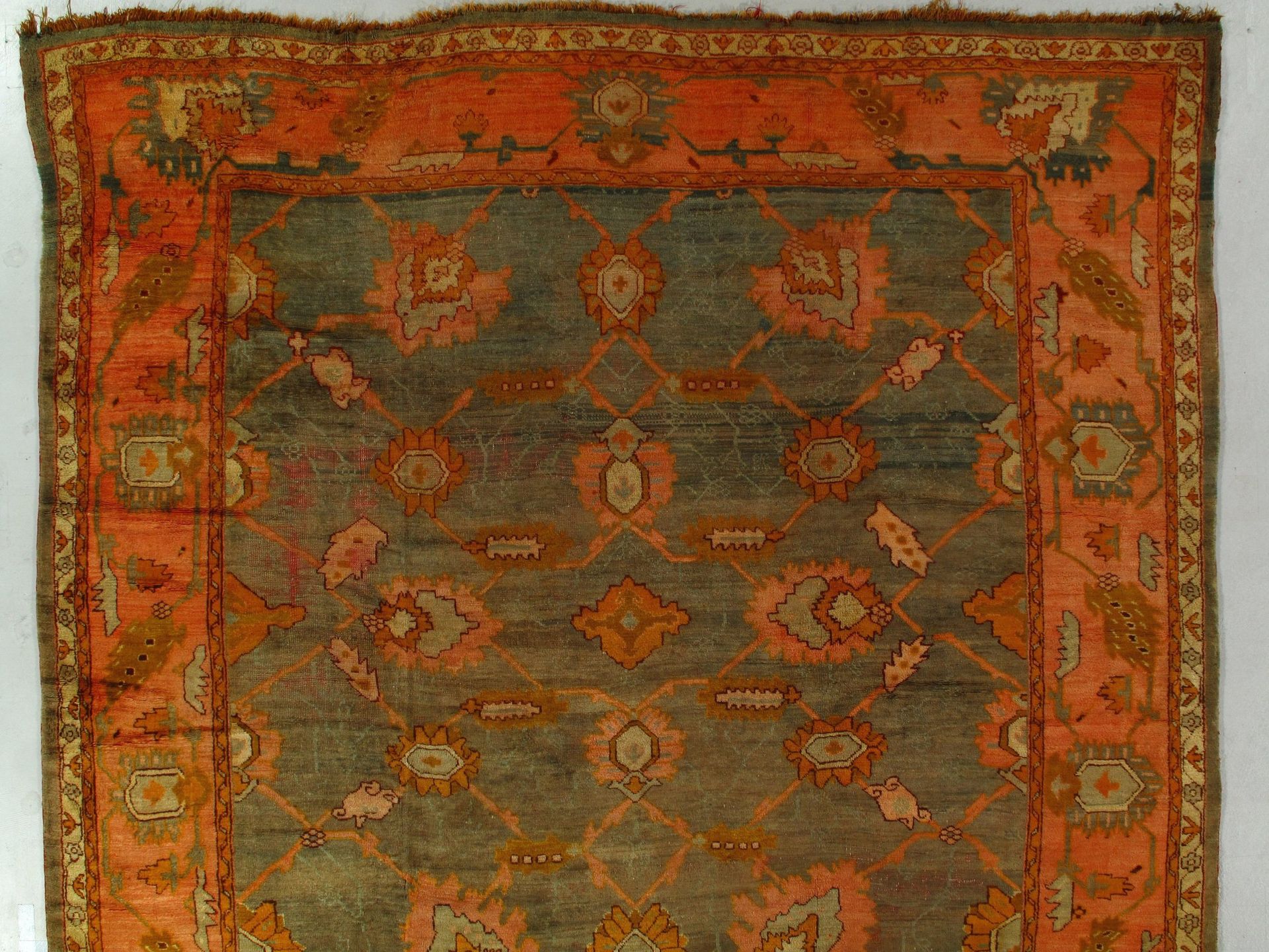 A rug with a pattern on it is sitting on a white surface.