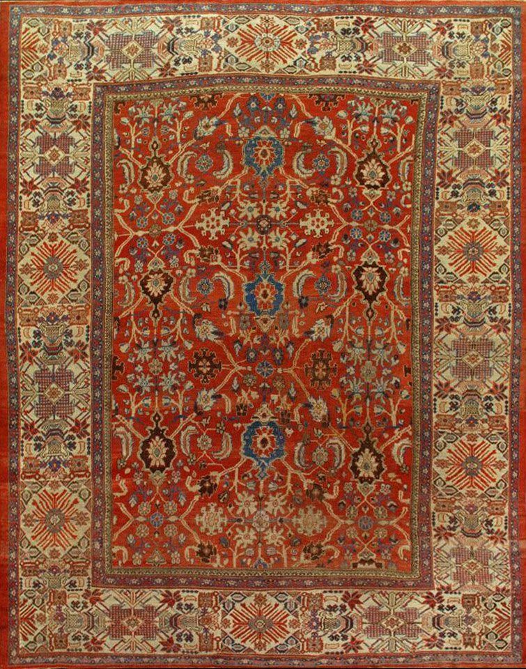 A red rug with a floral pattern on it