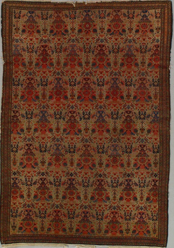 A rug with a pattern on it is hanging on a wall.