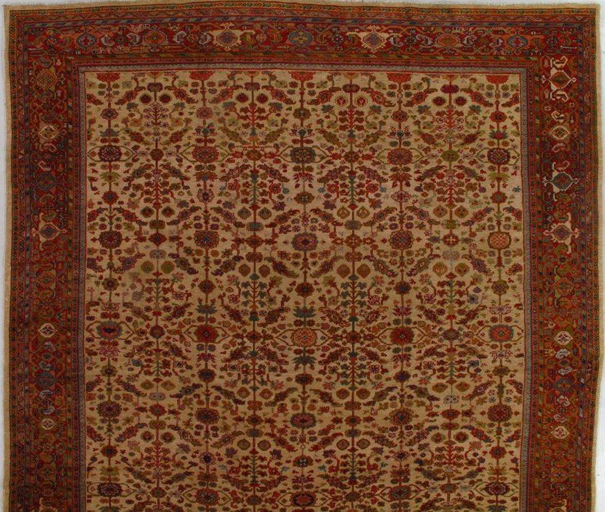 A rug with a floral pattern and a brown frame
