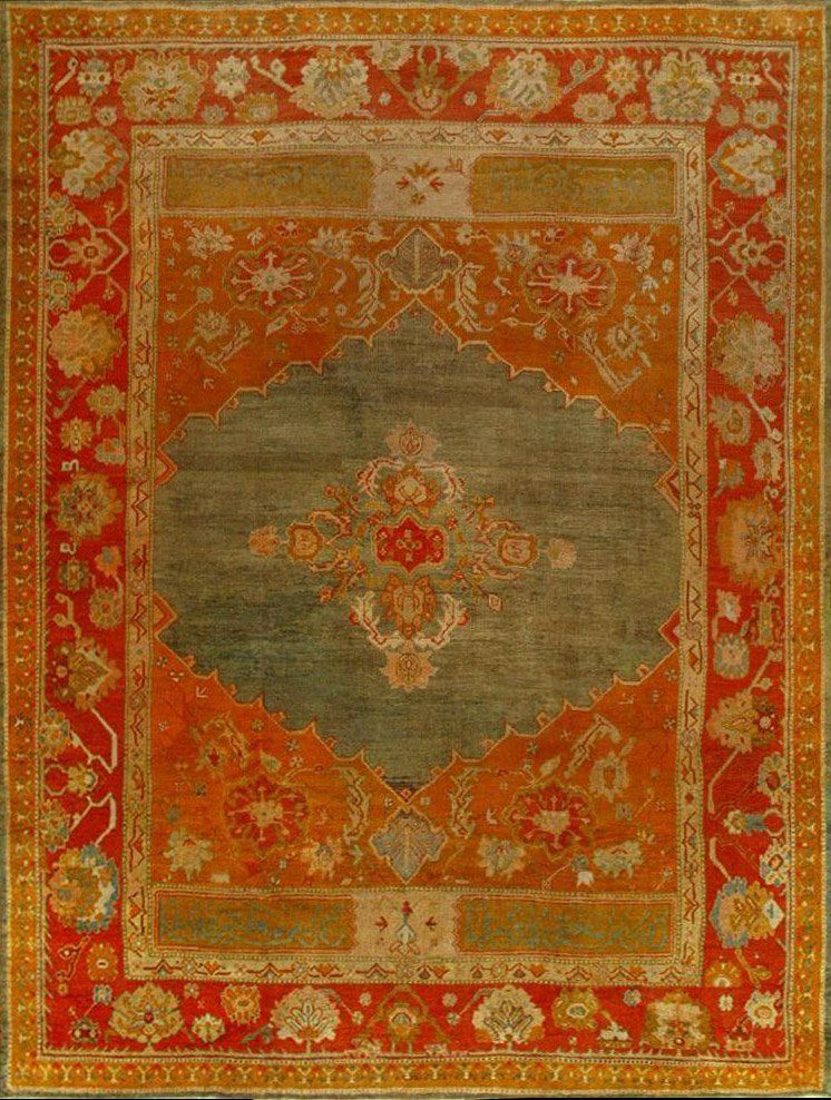 A red and green rug with a floral pattern on it